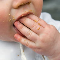 Photo of a child eating.
